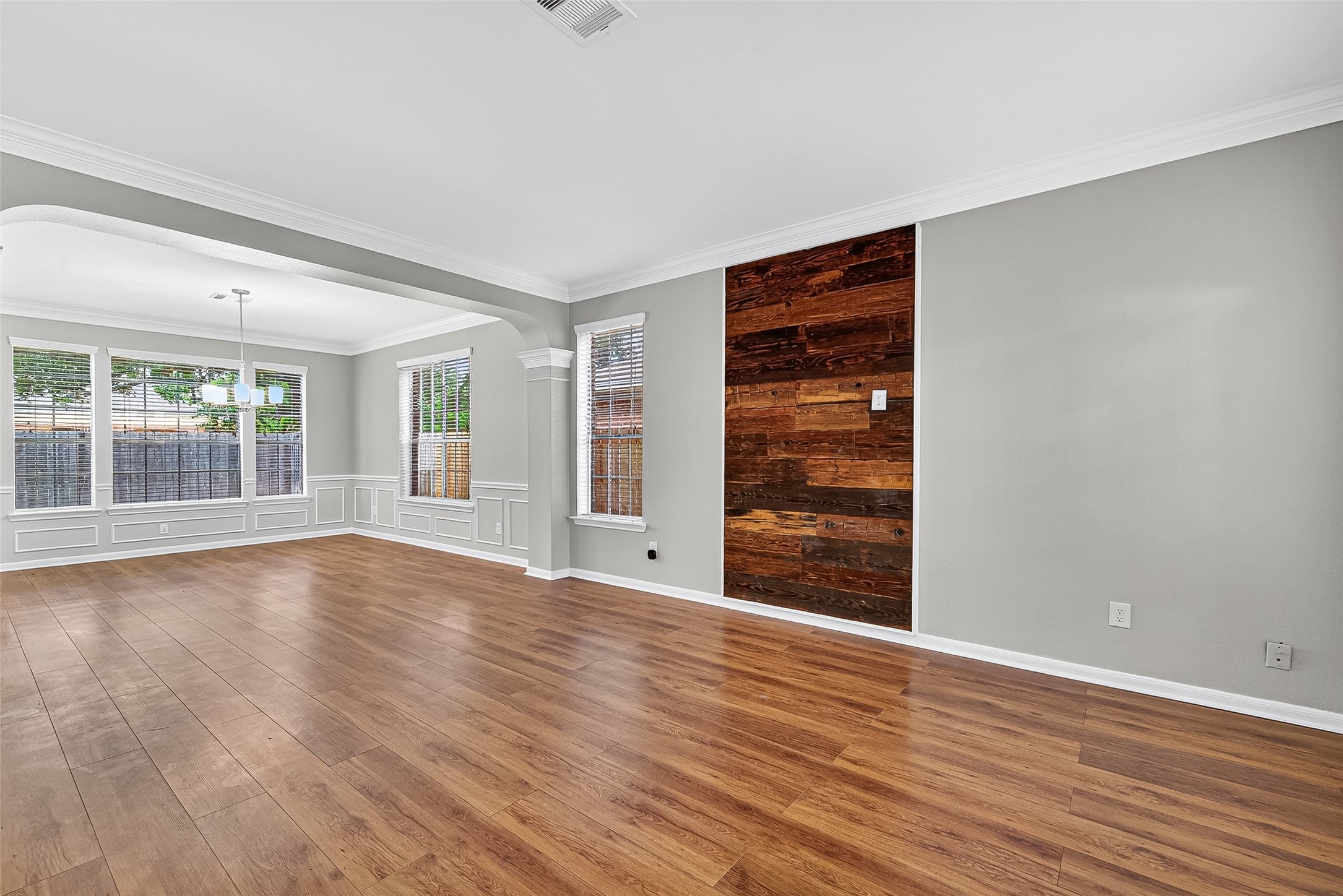 7411 Pacific Ridge Court Houston, TX 77095 - Photo 9 of 50 a view of an empty room with wooden floor and a window