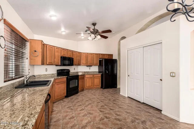 a large white kitchen with a large window
