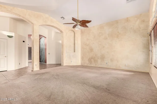 a view of a room with a ceiling fan and a shower