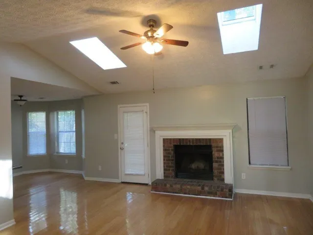 a view of a livingroom with a fireplace and window