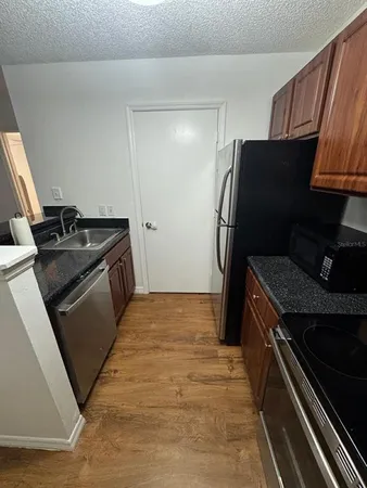a kitchen with a stove and a refrigerator