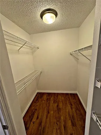a view of a room with wooden floor and white walls