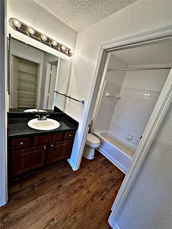 a bathroom with a sink a mirror and a shower