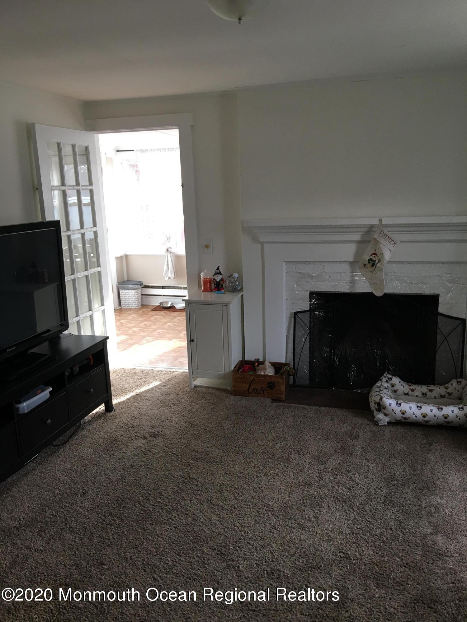 3 Stuyvesant Road Brick, NJ 08723 - Photo 2 of 10 a living room with furniture and a fireplace