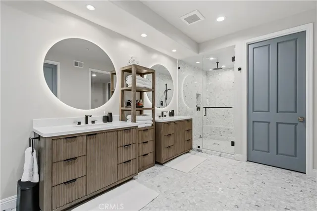 a spacious bathroom with a double vanity sink and a mirror