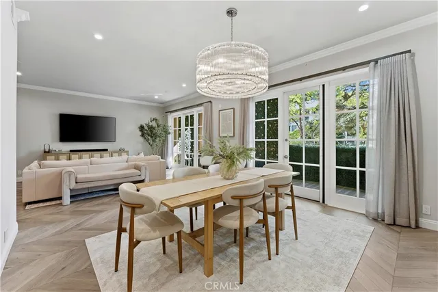 a view of a dining room with furniture wooden floor and chandelier