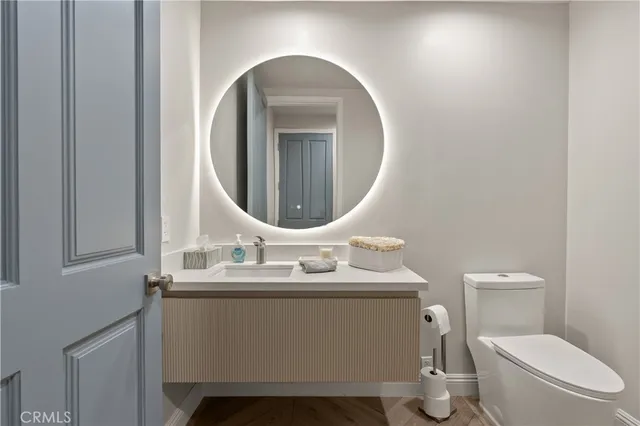 a bathroom with a toilet sink and mirror