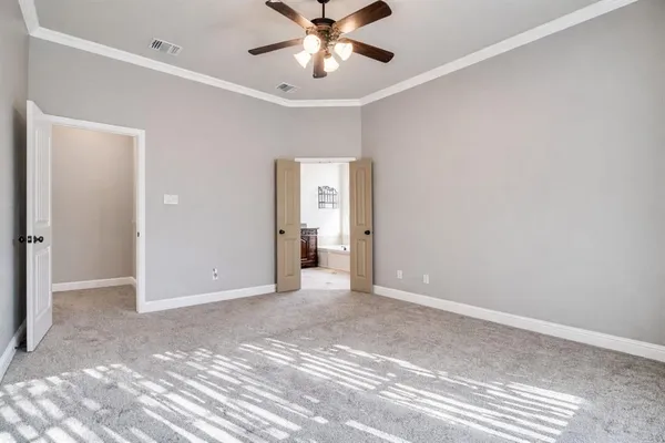 a view of an empty room with a ceiling fan