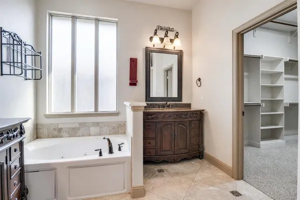 a bathroom with a bathtub a sink and a window