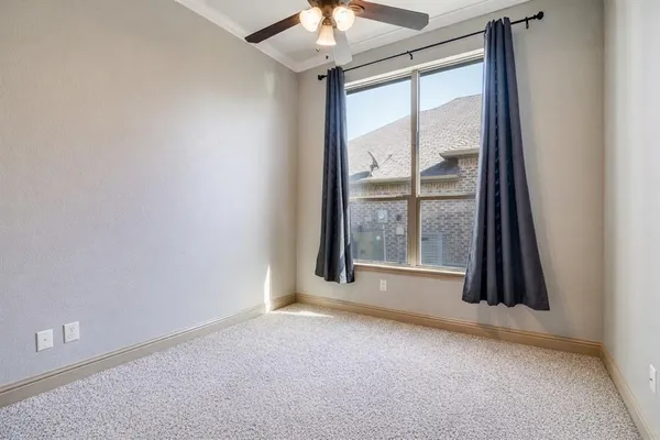 an empty room with a fireplace and a large window