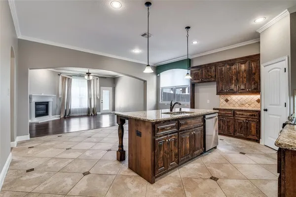 a kitchen with stainless steel appliances granite countertop a stove a sink a oven and a refrigerator