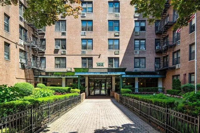 a front view of a building with a garden