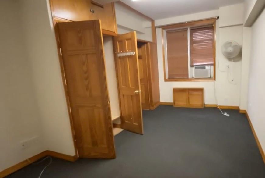 1237 Avenue Z, Unit NN Brooklyn, NY 11235 - Photo 12 of 12 a view of a closet with wooden walls