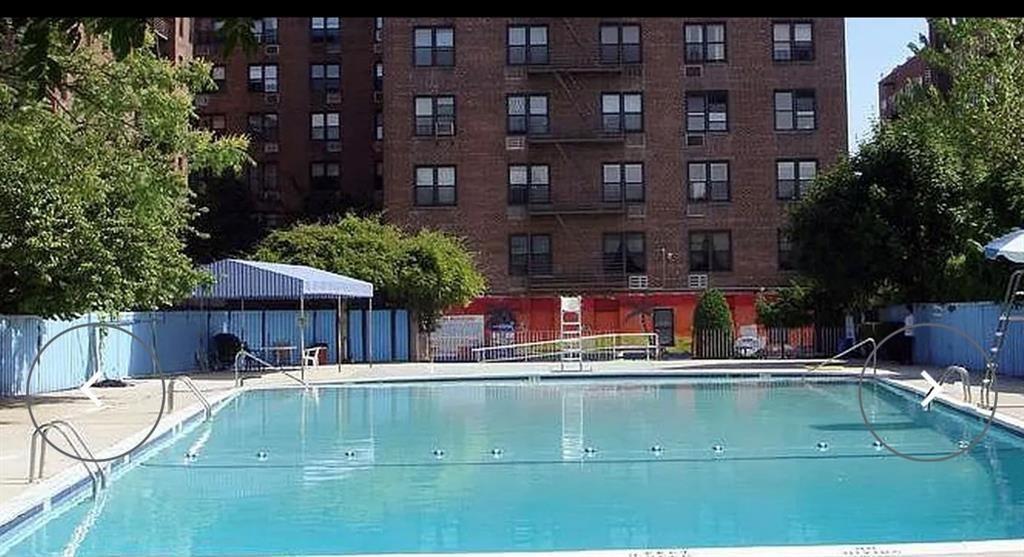 1237 Avenue Z, Unit NN Brooklyn, NY 11235 - Photo 4 of 12 a swimming pool with outdoor seating and yard