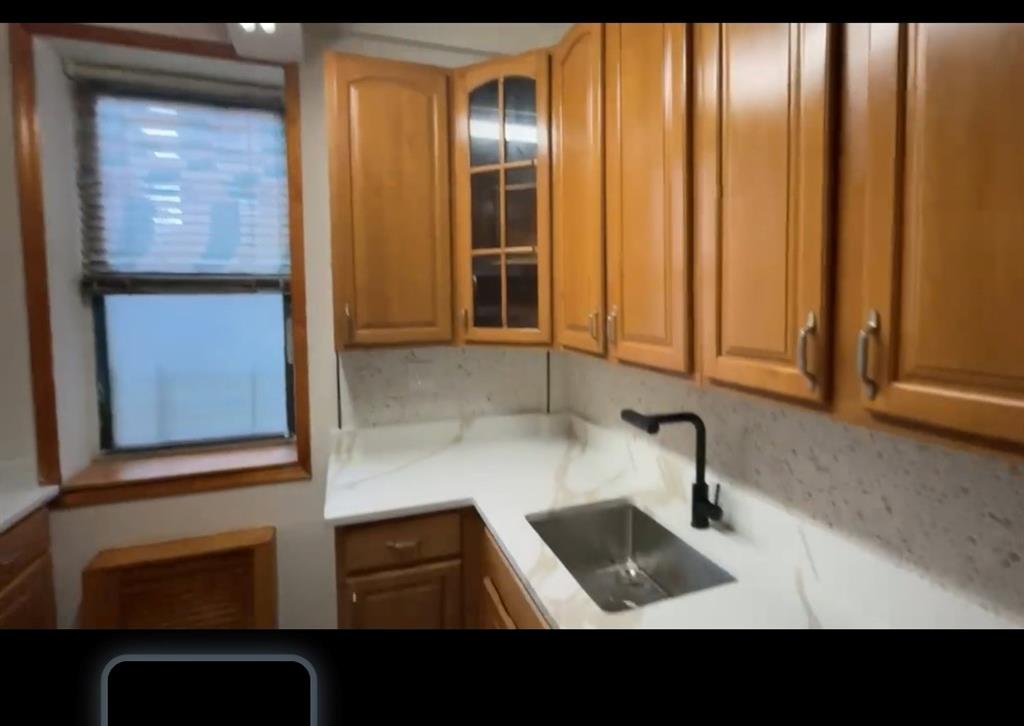 1237 Avenue Z, Unit NN Brooklyn, NY 11235 - Photo 8 of 12 a bathroom with a sink and a mirror