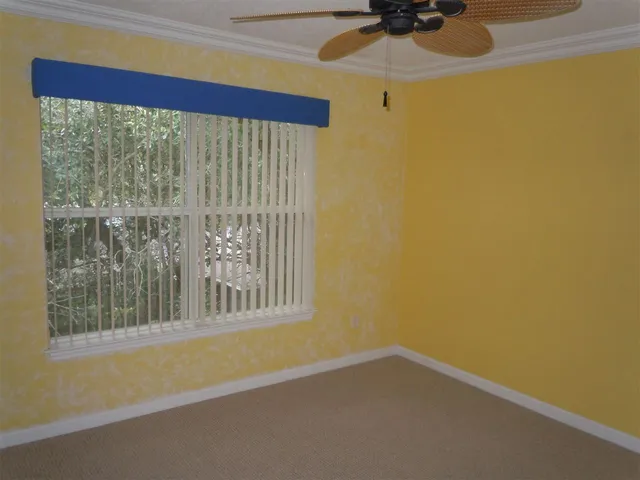 a view of a small space with wooden floor and a window