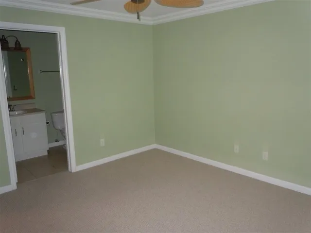 a bathroom with a shower a toilet and a sink