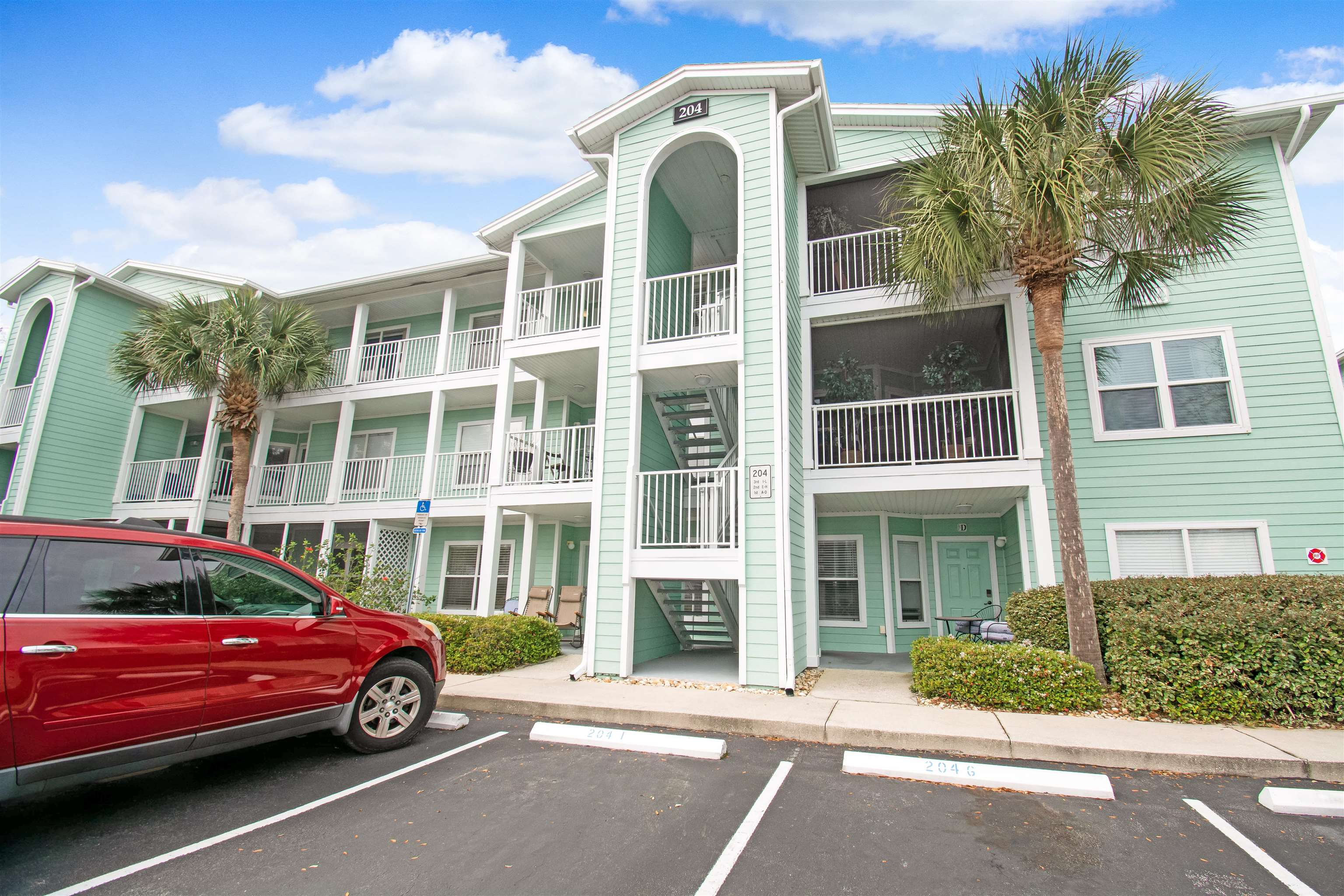 204 J 16th Street St. Augustine Beach, FL 32080 - Photo 2 of 21 a front view of a house with a yard