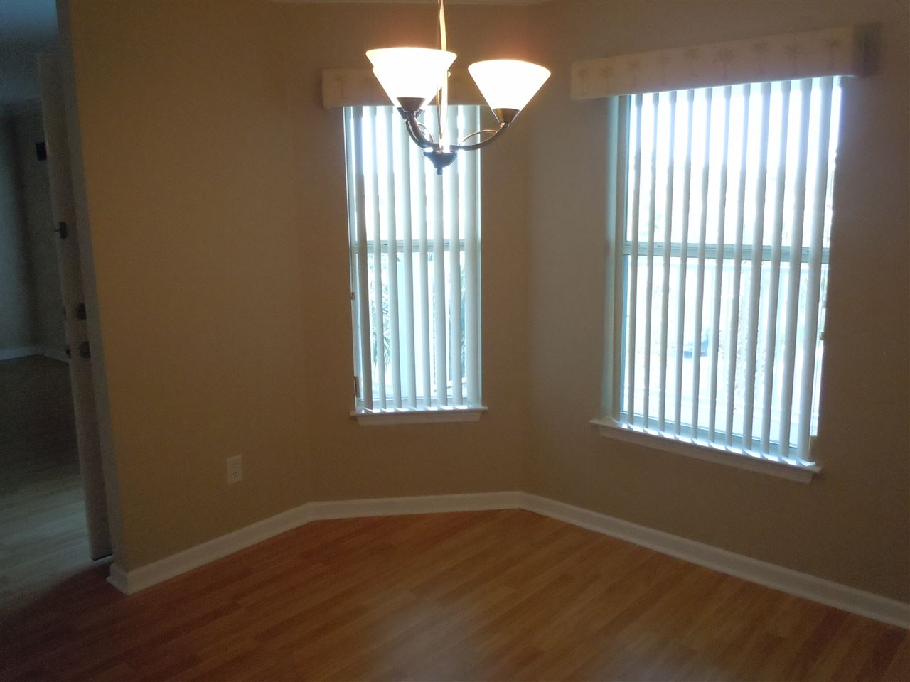 204 J 16th Street St. Augustine Beach, FL 32080 - Photo 6 of 21 a view of an empty room with wooden floor and a window