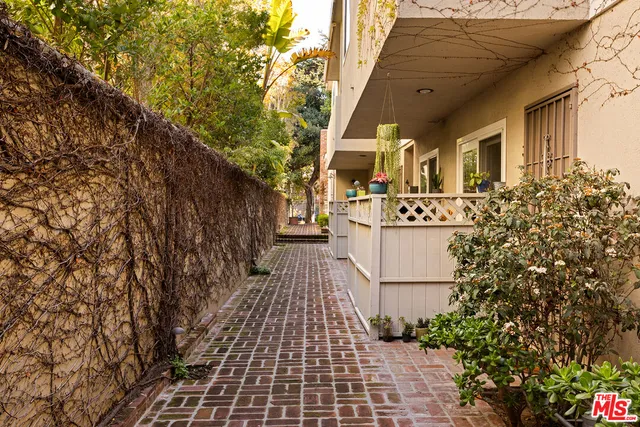 a view of a white house with a yard