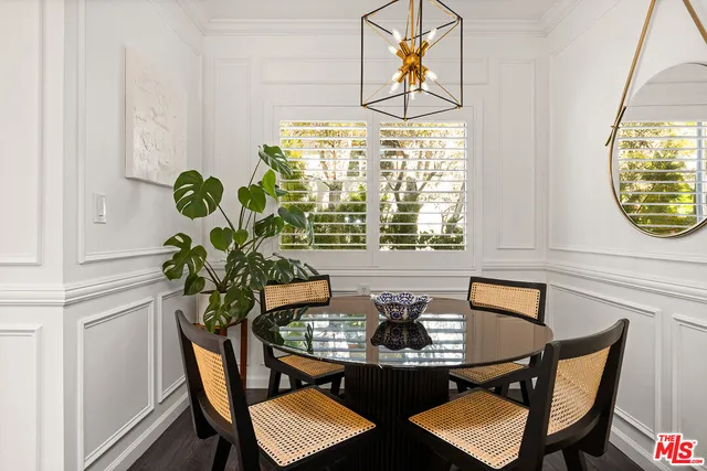a view of a dining room with furniture and chandelier