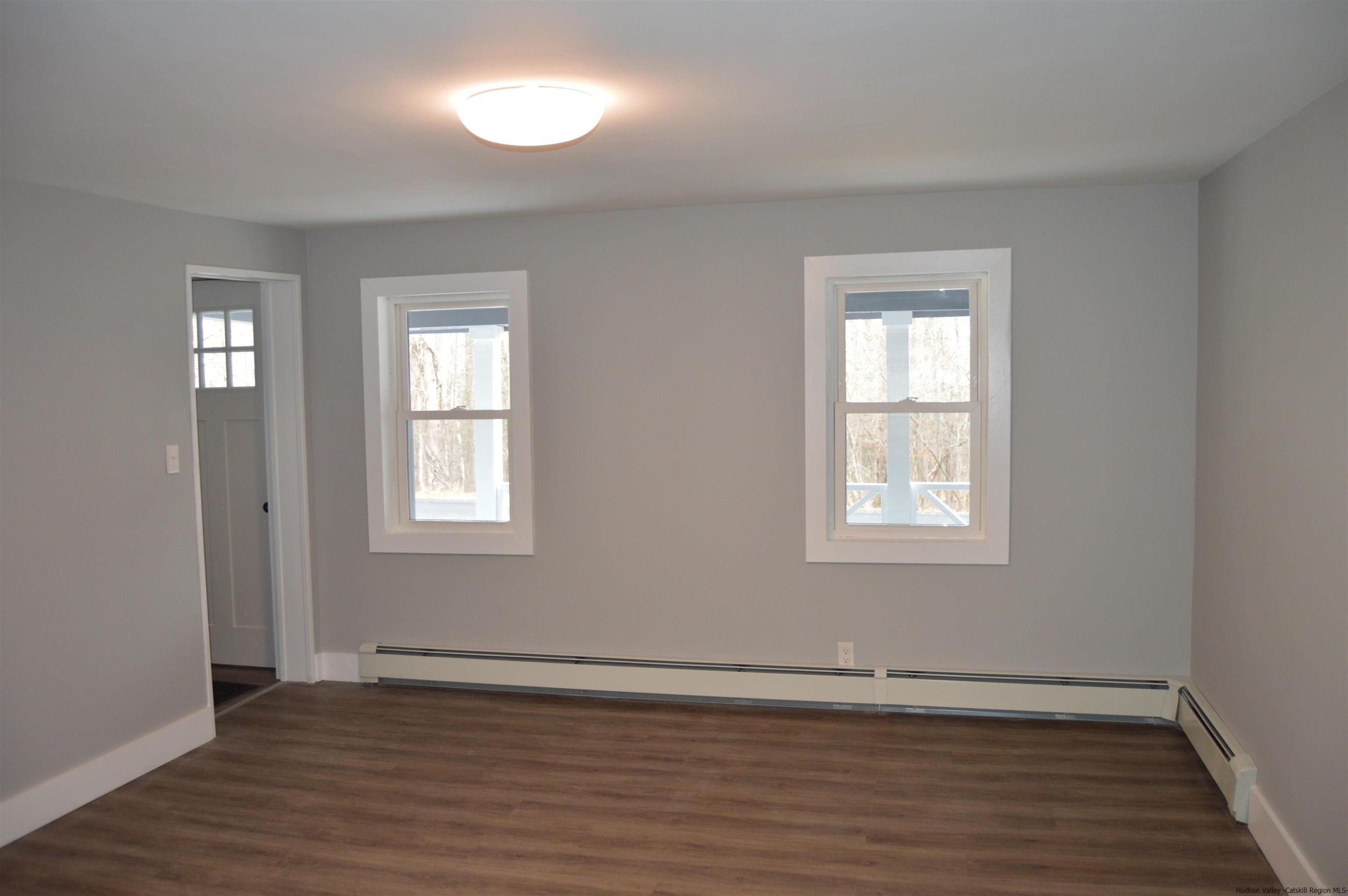 128 Cole Bank Road Saugerties, NY 12477 - Photo 14 of 26 a view of an empty room with wooden floor and a window