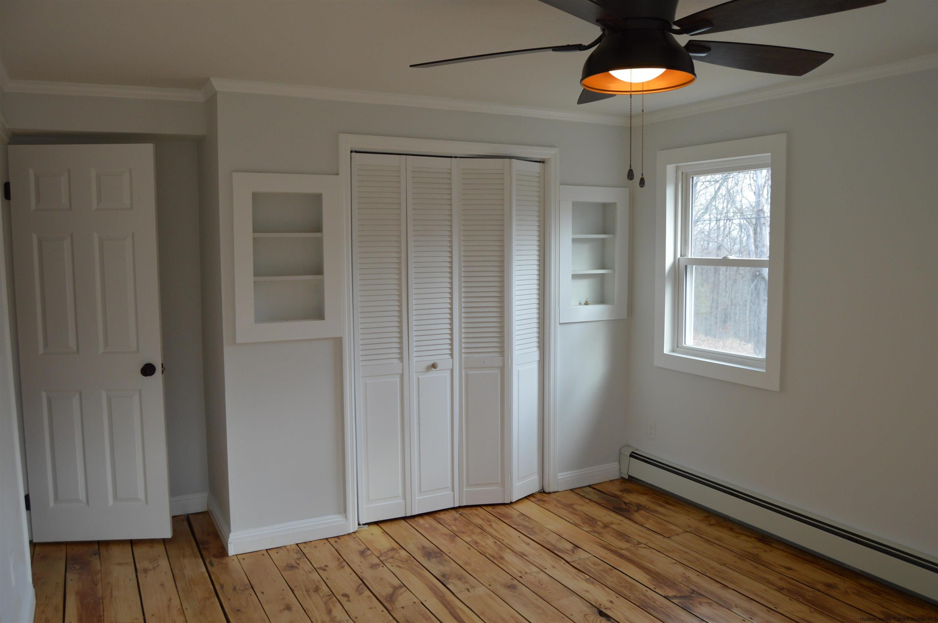 128 Cole Bank Road Saugerties, NY 12477 - Photo 16 of 26 a view of an empty room with wooden floor and a window
