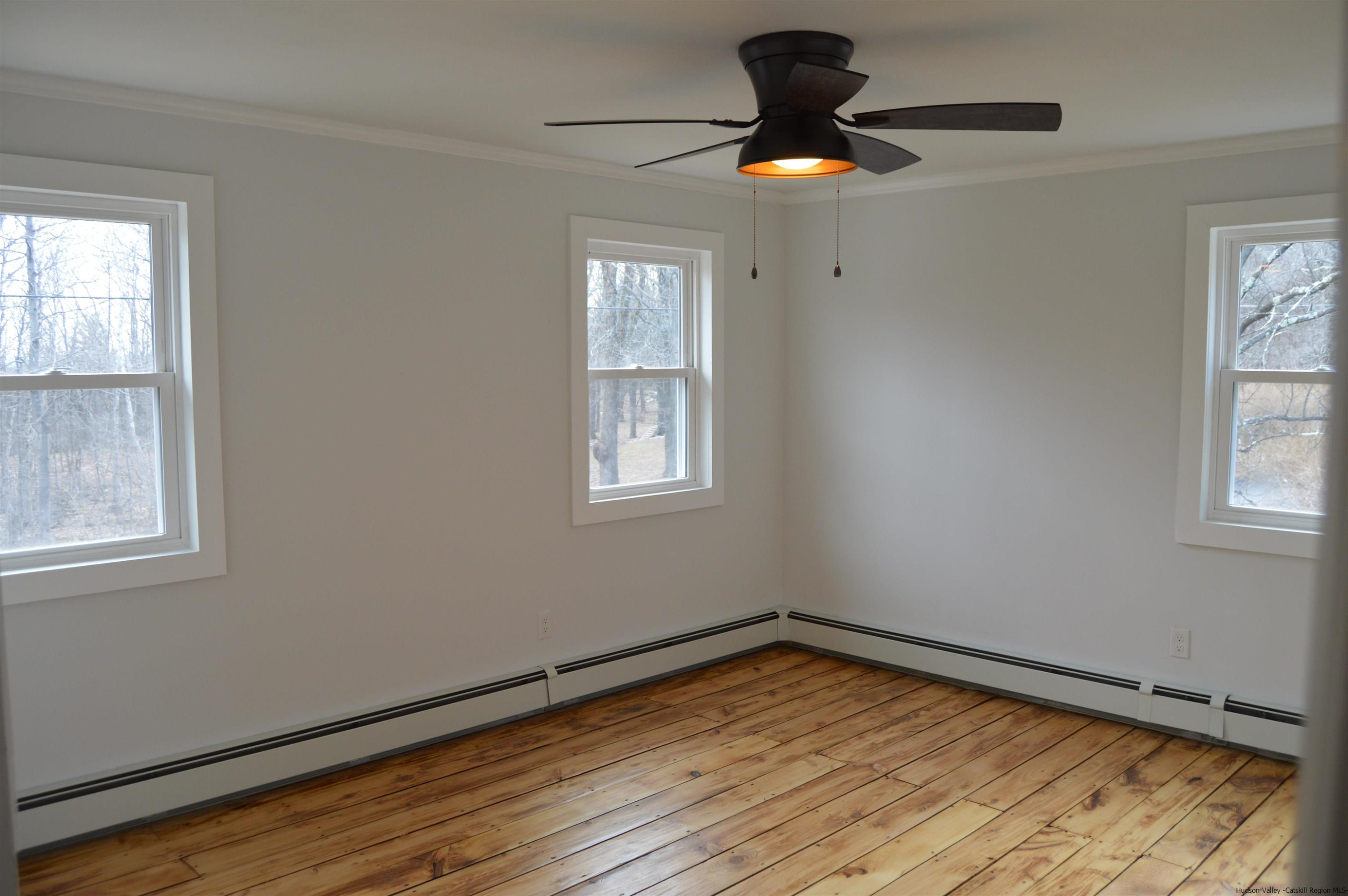 128 Cole Bank Road Saugerties, NY 12477 - Photo 17 of 26 a view of empty room with wooden floor and fan