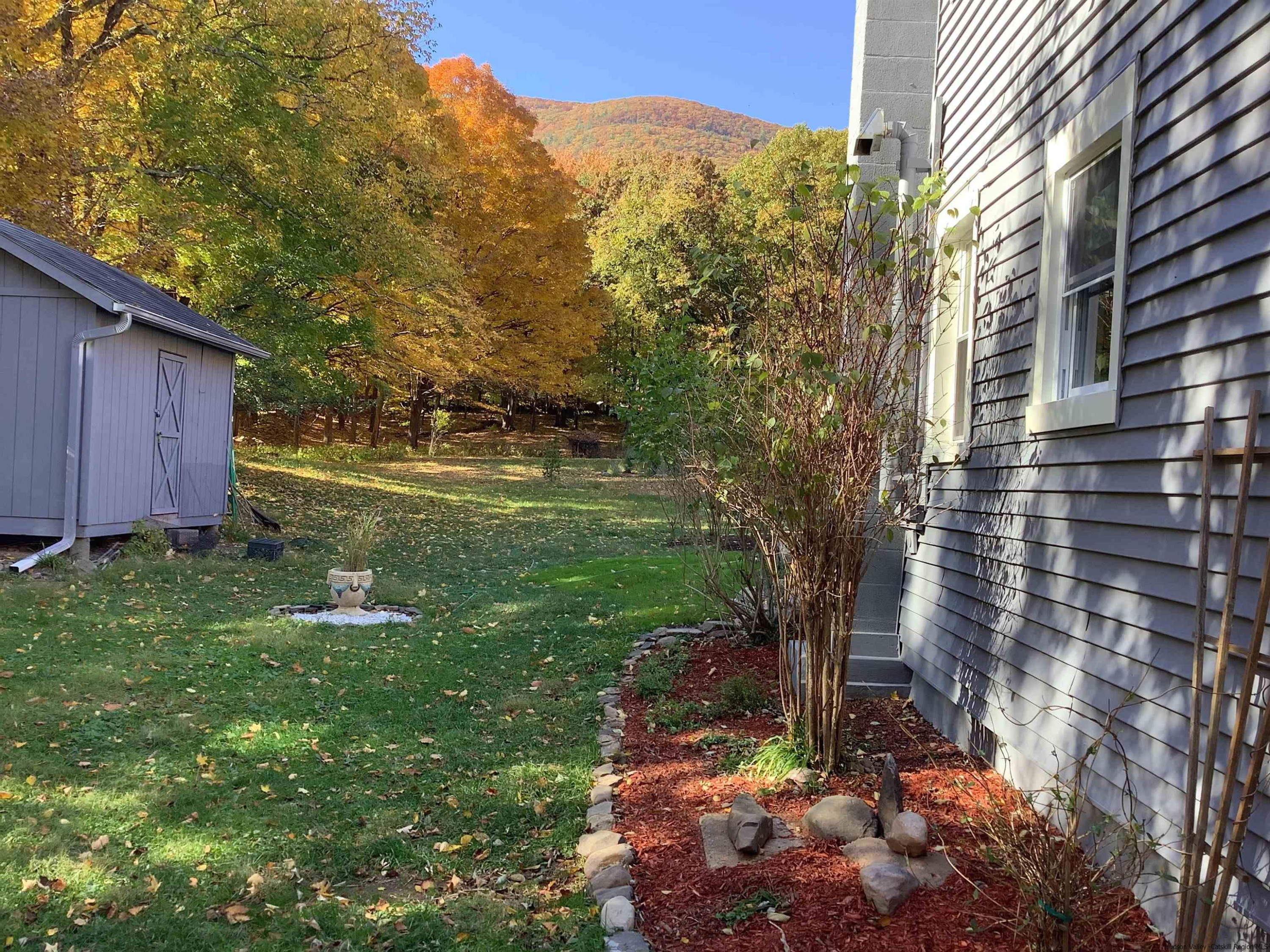 128 Cole Bank Road Saugerties, NY 12477 - Photo 23 of 26 a view of a backyard with plants and large trees