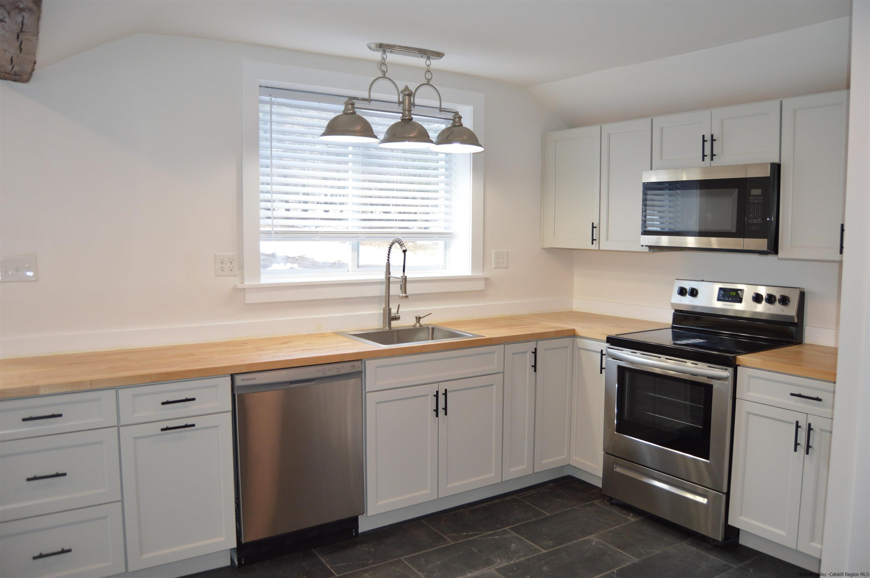 128 Cole Bank Road Saugerties, NY 12477 - Photo 3 of 26 a kitchen with cabinets stainless steel appliances a sink and a window