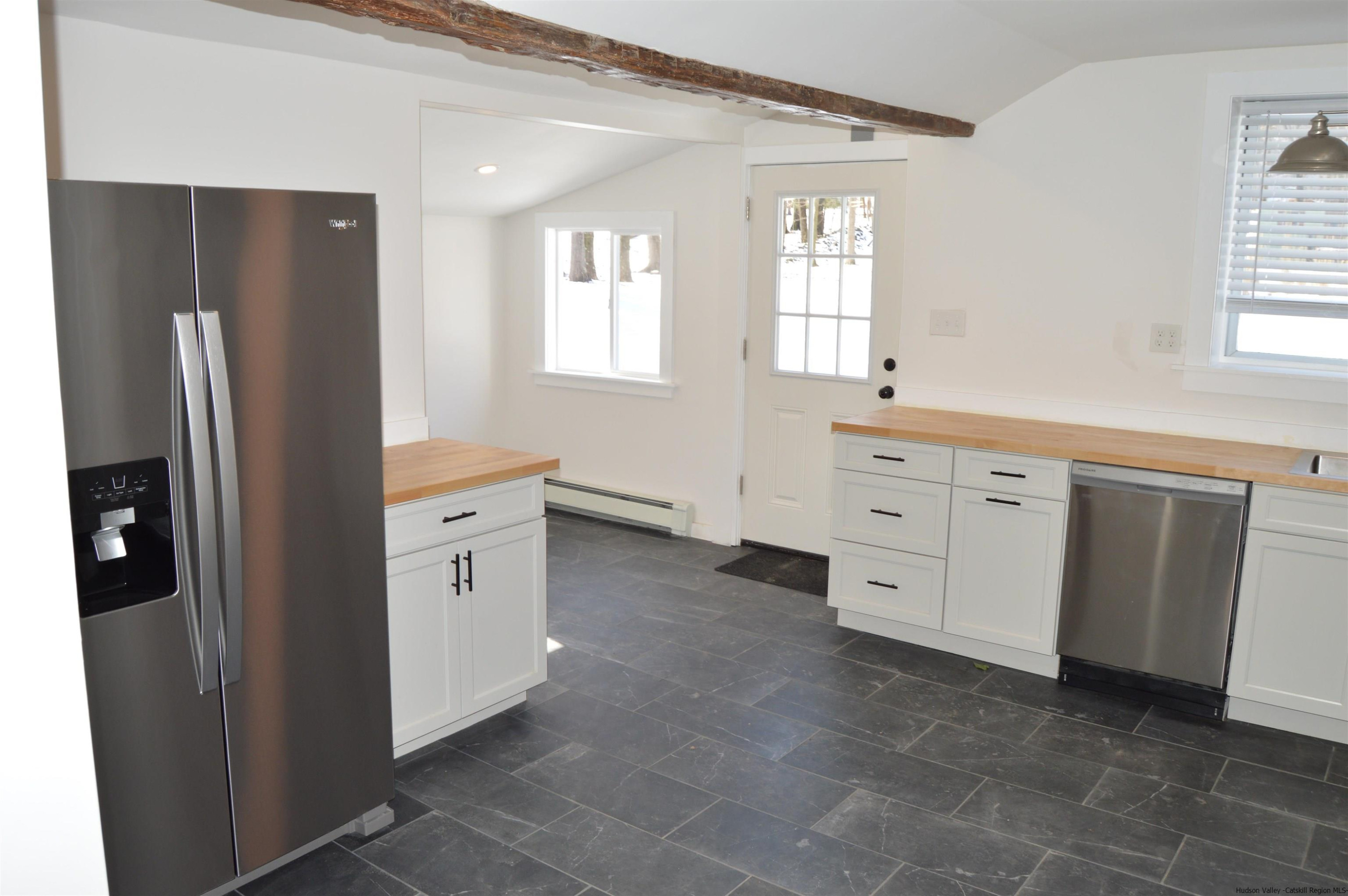 128 Cole Bank Road Saugerties, NY 12477 - Photo 4 of 26 a kitchen with white cabinets and refrigerator