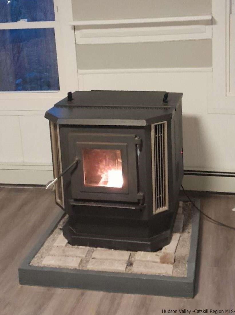 128 Cole Bank Road Saugerties, NY 12477 - Photo 9 of 26 a living room with a fireplace and a rug