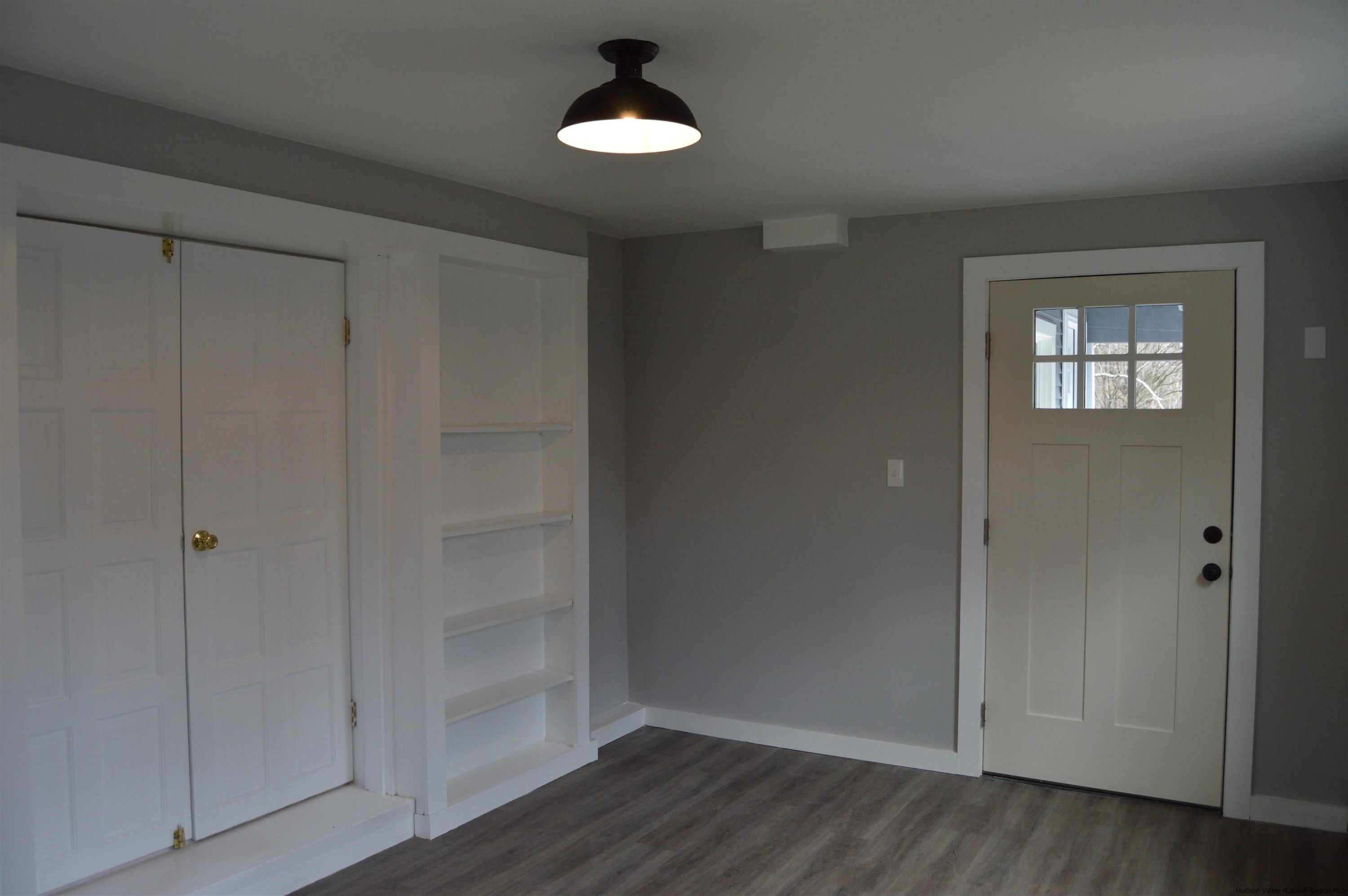 128 Cole Bank Road Saugerties, NY 12477 - Photo 10 of 26 a view of empty room with wooden floor and fan
