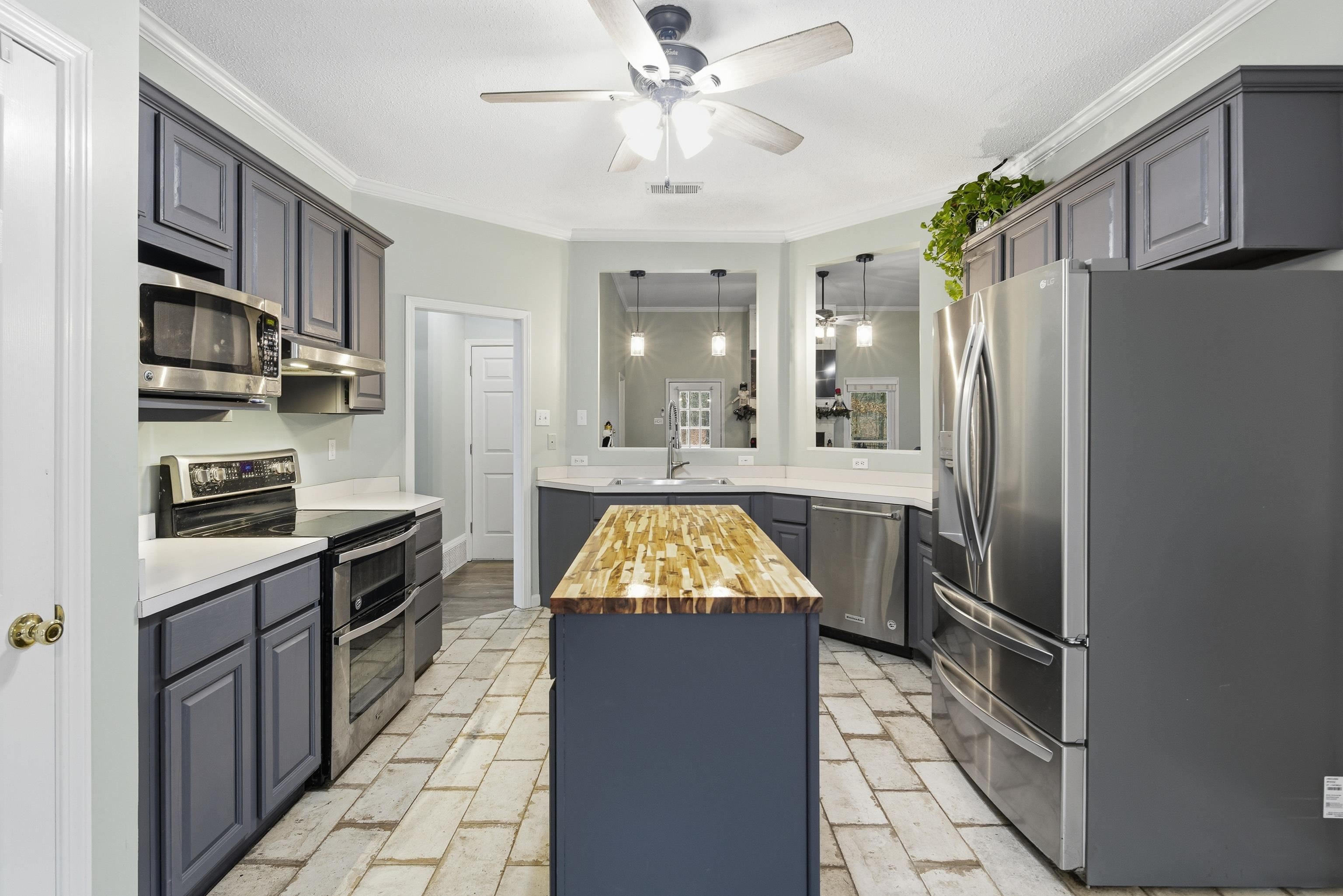 1755 Country Club Road Somerville, TN 38068 - Photo 23 of 40 Kitchen with wood counters, stainless steel appliances, crown molding, a kitchen island, and hanging light fixtures