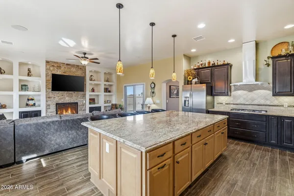 a kitchen with granite countertop a sink stainless steel appliances and cabinets