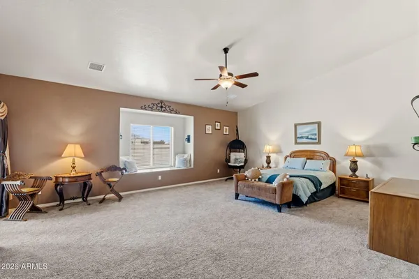 a living room with furniture a flat screen tv and a window