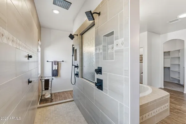 a large bathroom with a sink a large mirror and a shower