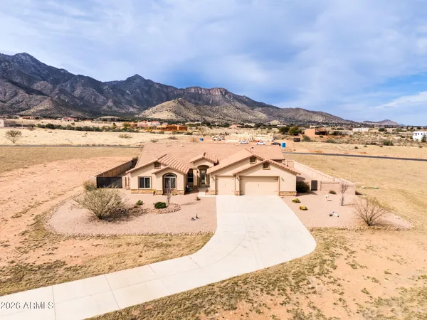 an aerial view of a house with outdoor space and lake view in back