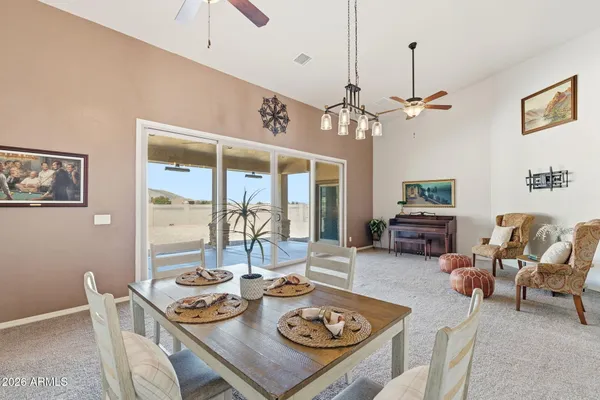 a living room with furniture a chandelier and a table