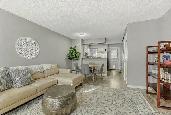 a living room with furniture and a book shelf