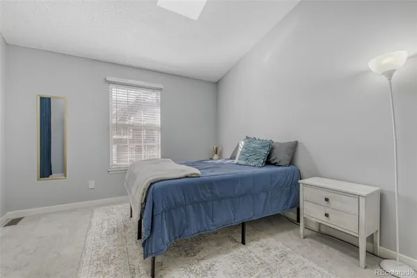 a bed room with a bed and a window