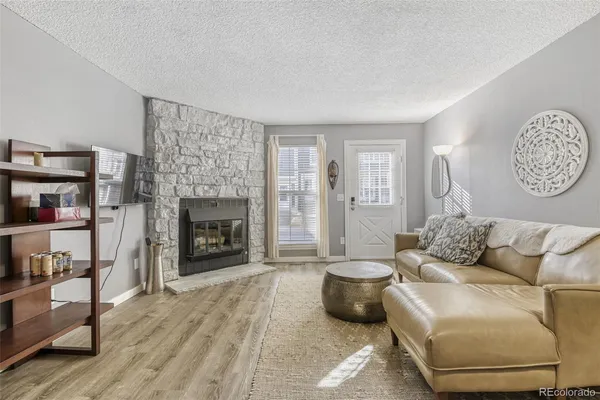 a living room with furniture and a fireplace