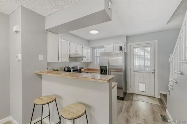 a kitchen with a refrigerator a stove top oven a sink and dishwasher