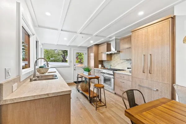 a kitchen with a sink and wooden floor