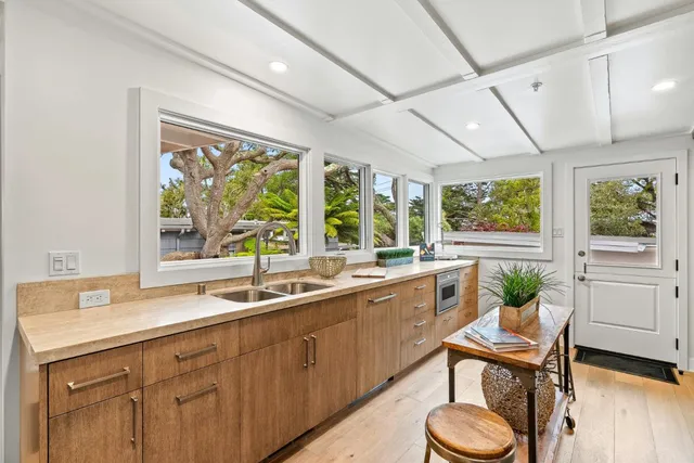a kitchen with stainless steel appliances a stove a sink and a refrigerator