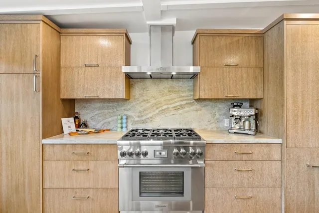 a kitchen with stainless steel appliances a stove and a refrigerator