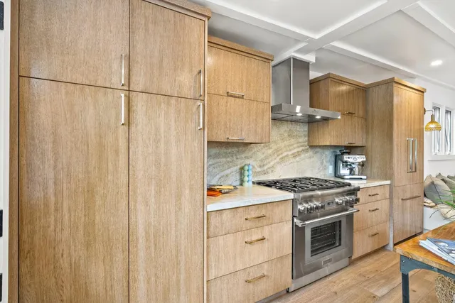 a close view of a stove top oven and refrigerator