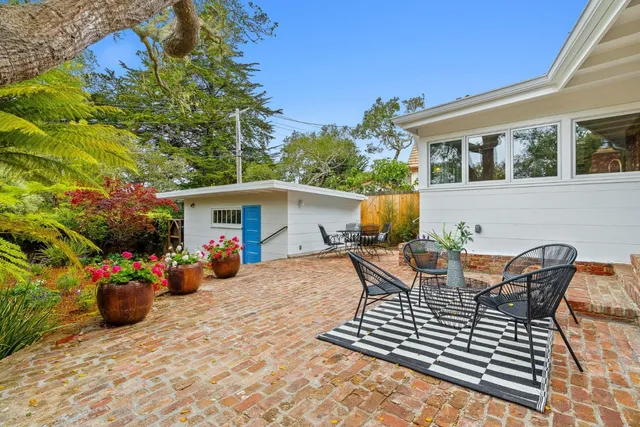 a view of a patio with table and chairs and potted plants