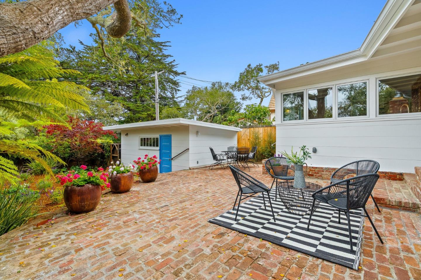 0 Santa Fe 4 Se Of Ocean Avenue Carmel, CA 93923 - Photo 3 of 34 a view of a patio with table and chairs and potted plants