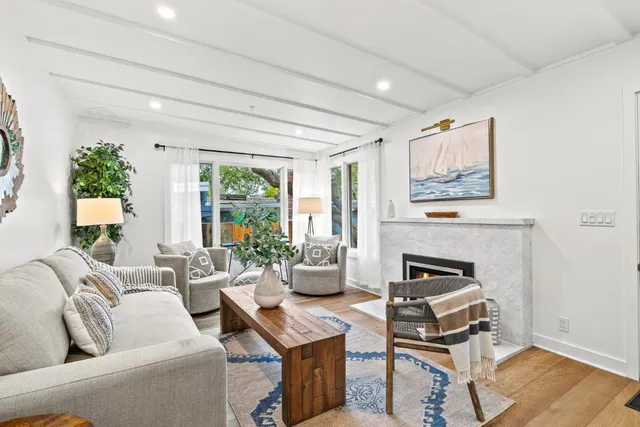 a living room with furniture wooden floor and a fireplace